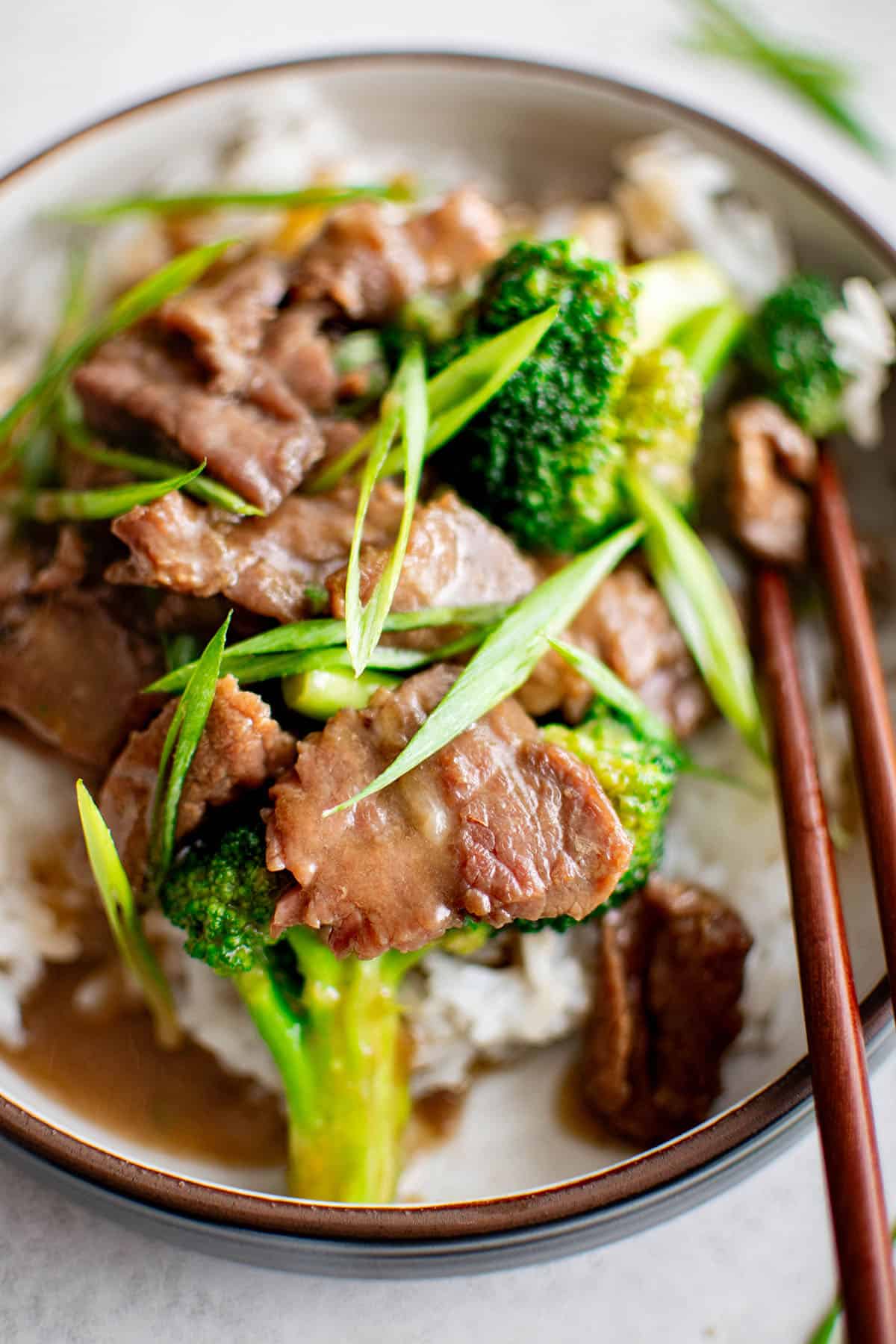 beef and broccoli in a bowl with rice