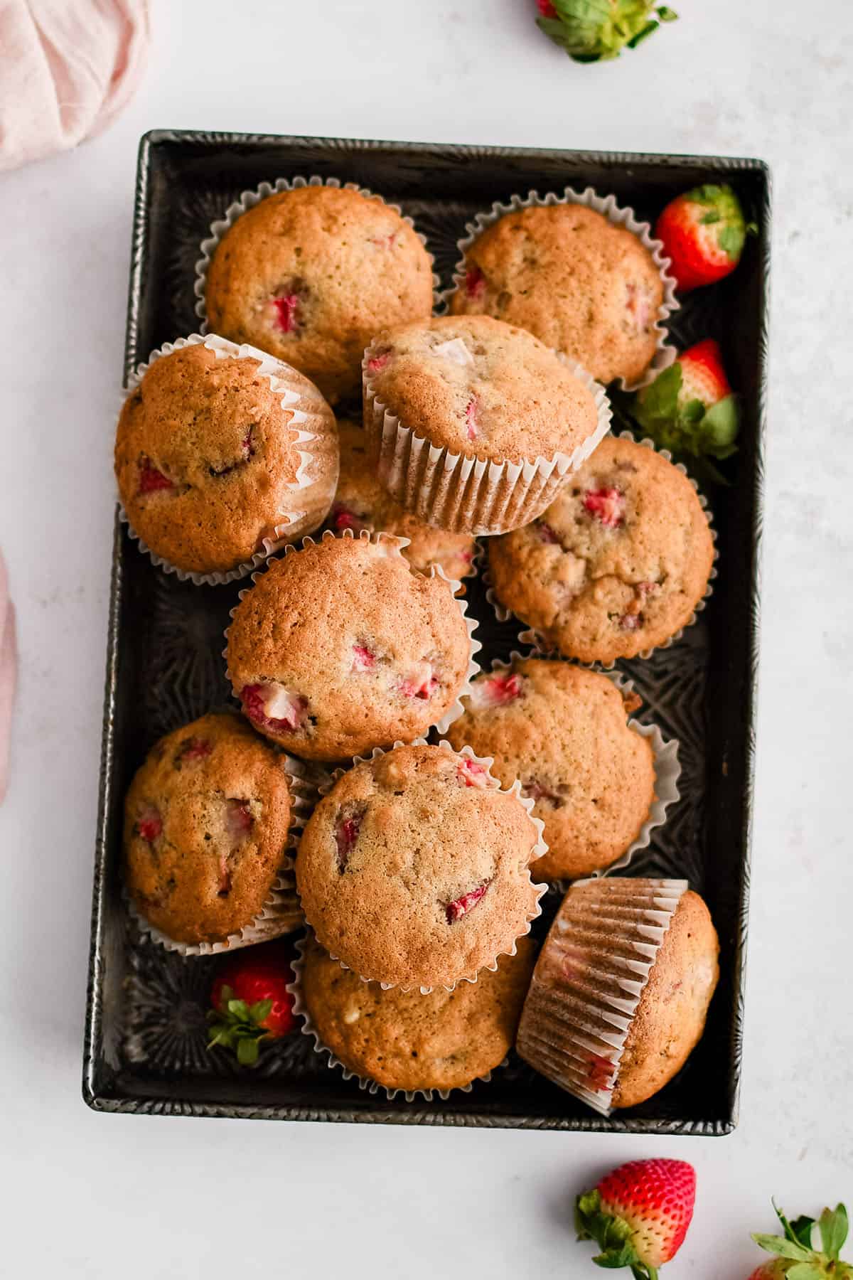 strawberry banana muffins on a baking sheet