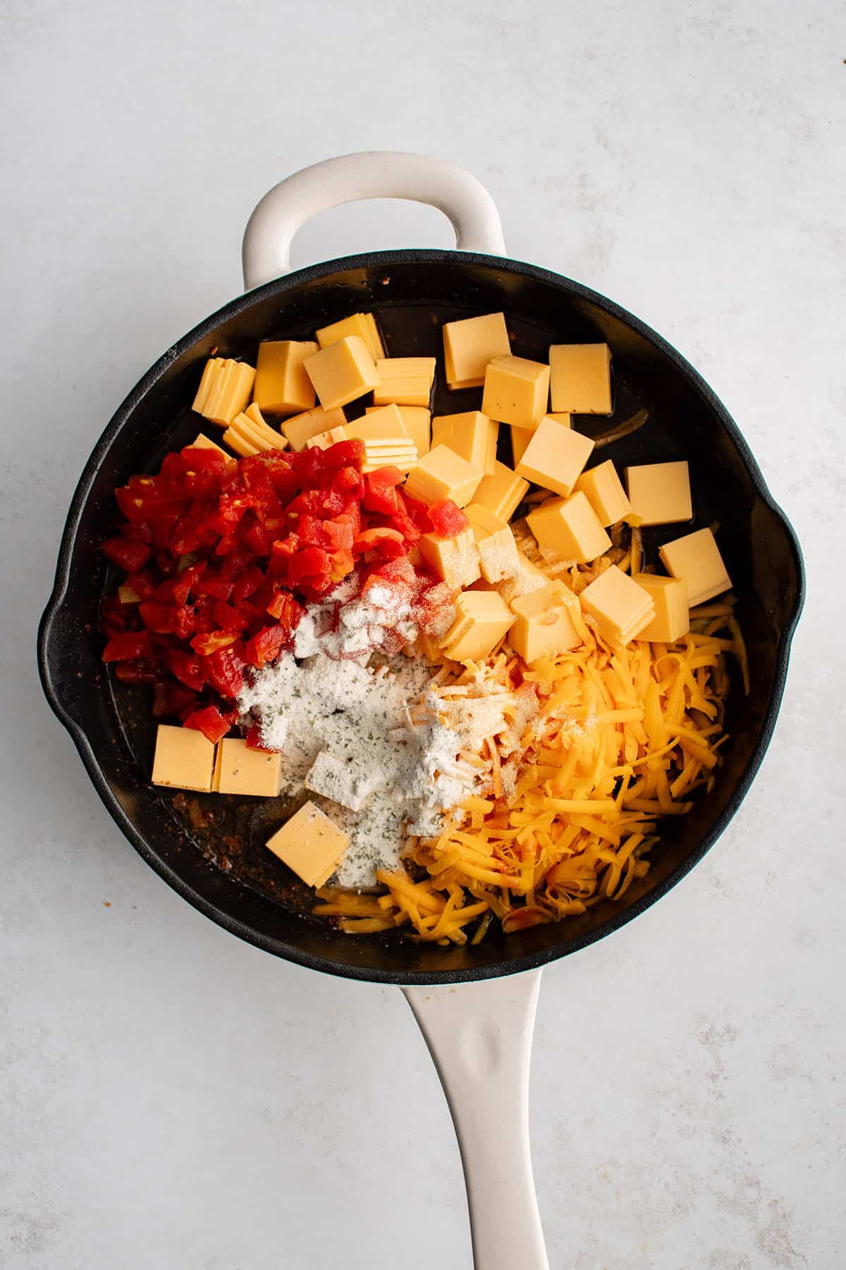 ingredients to make cheese dip with bacon in a skillet