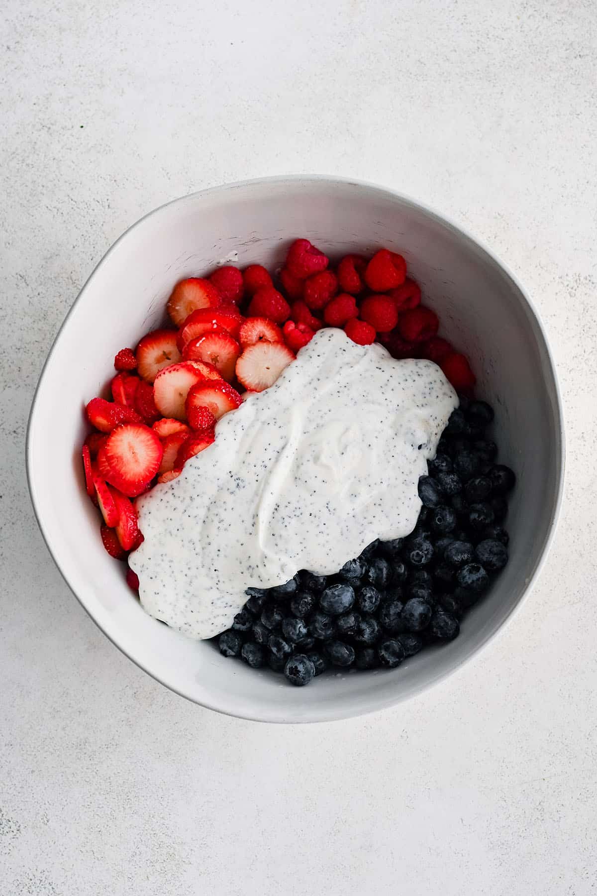 ingredients to make berry salad in a bowl