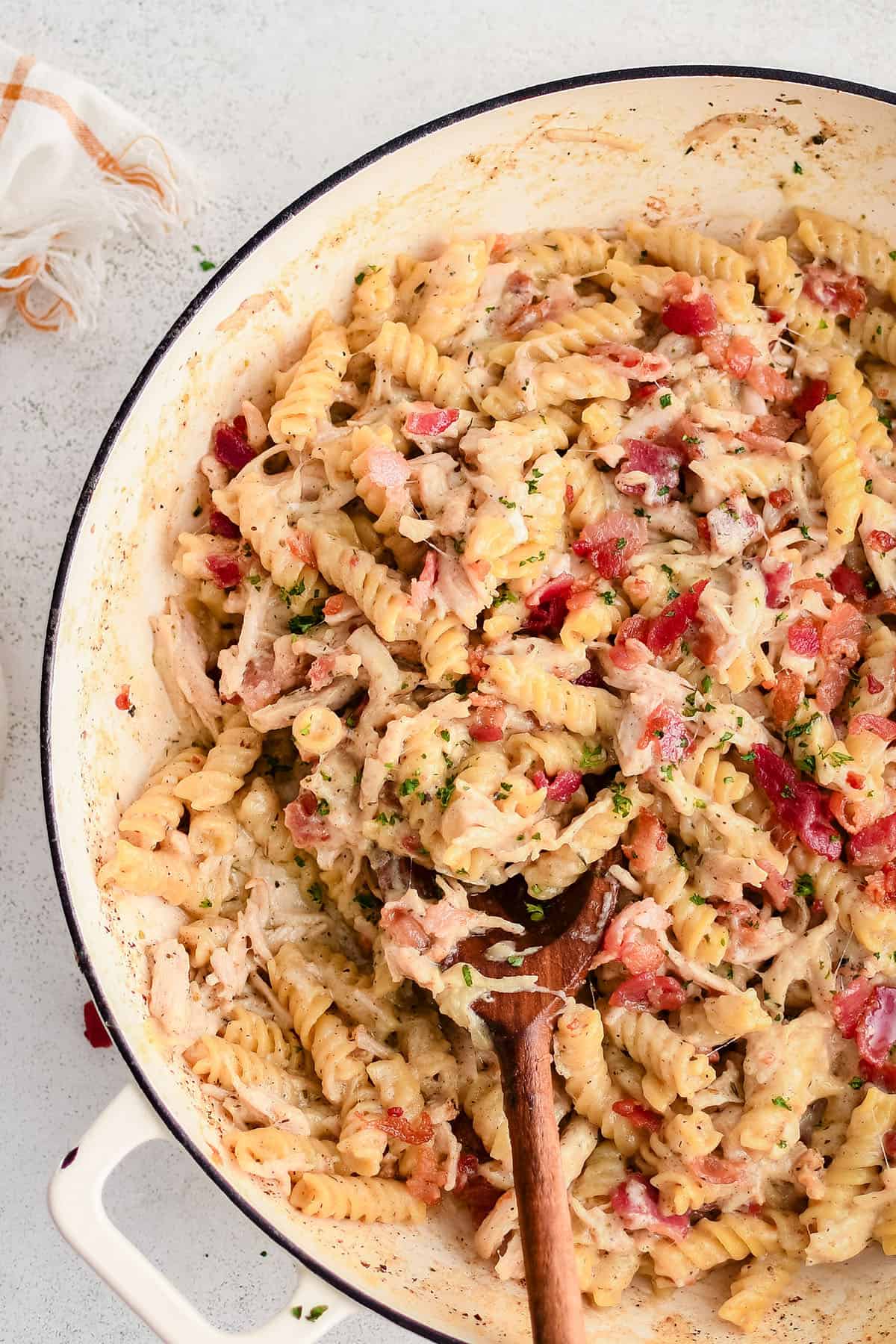 pasta with chicken and bacon in a white pot