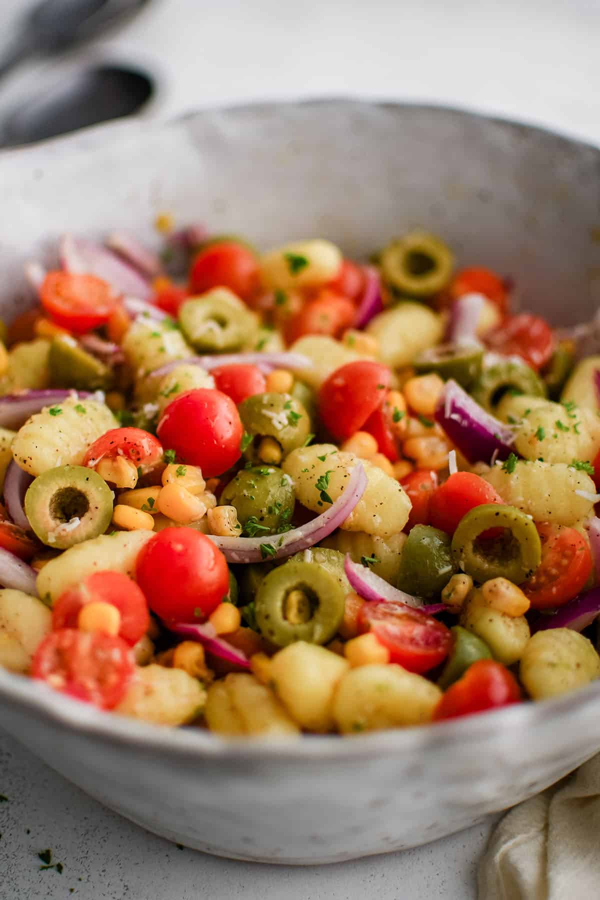 gnocchi salad in a bowl with veggies and dressing