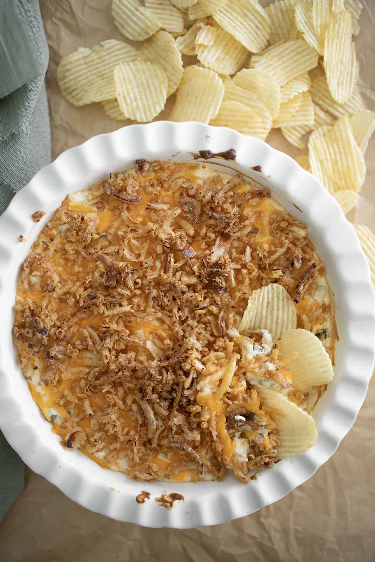 fried pickle dip in a dish with chips