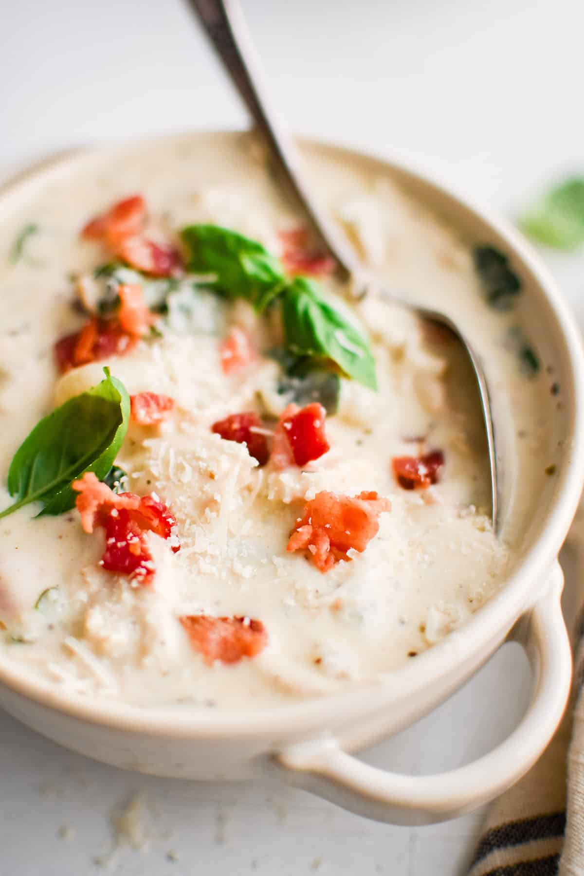 chicken gnocchi soup in a white bowl