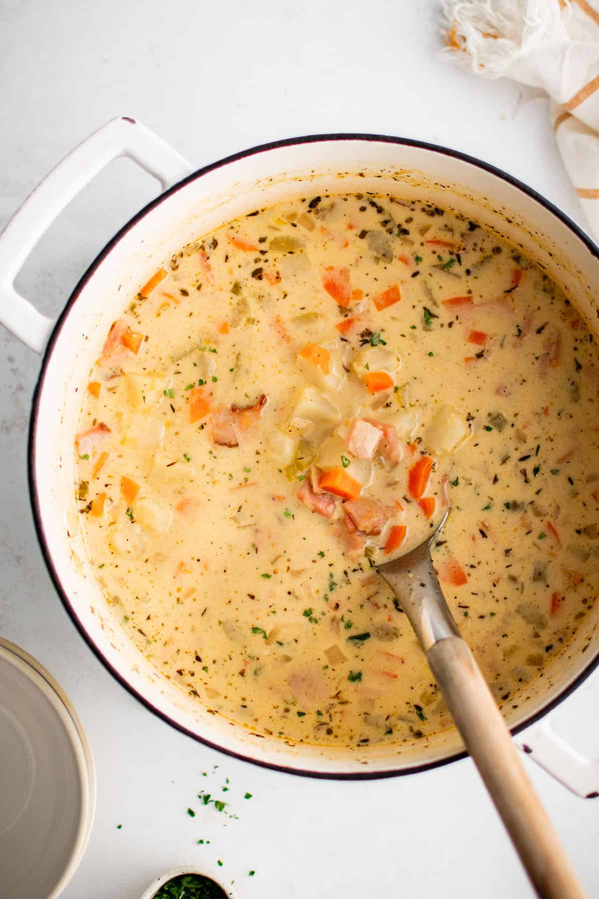 potato soup with ham in a cooking pot