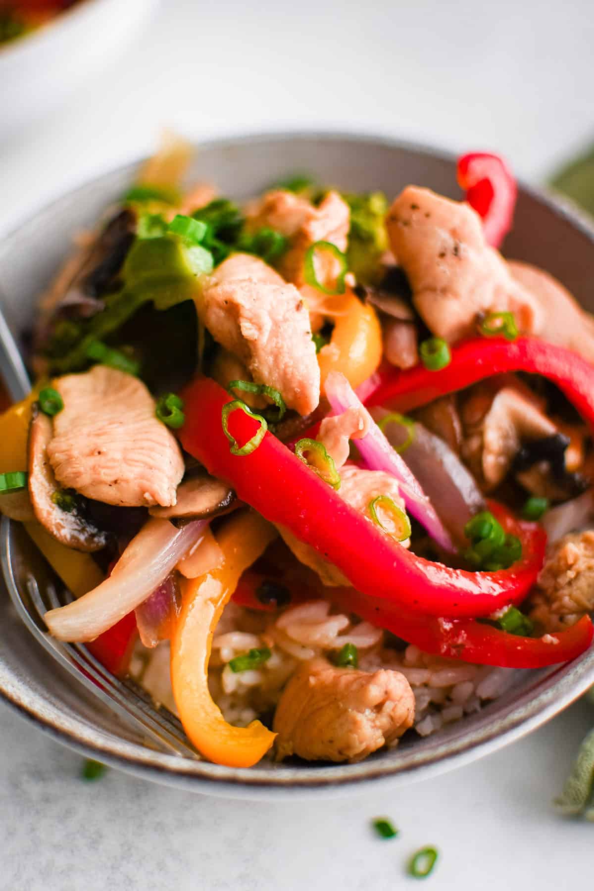 picture of chicken stir fry recipe in a bowl with rice