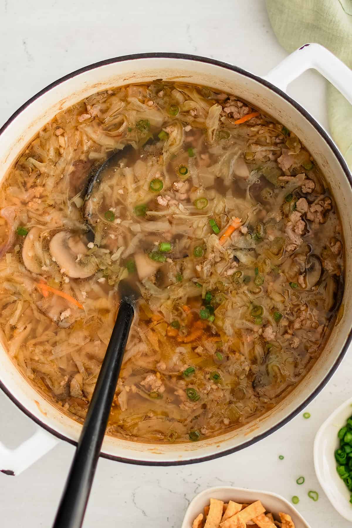 egg roll soup in a large soup pot with a ladle