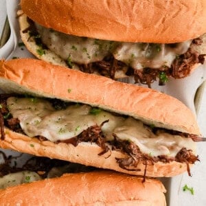 three french dip sandwiches with cheese