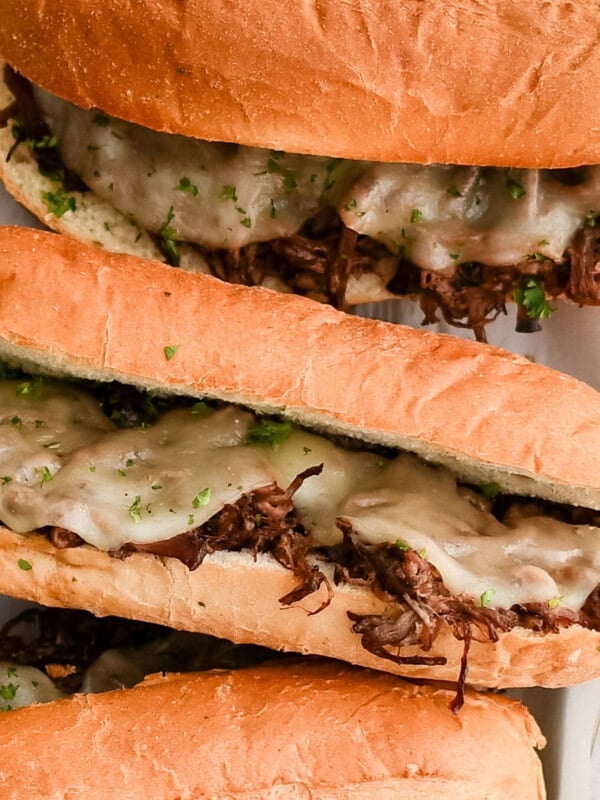 three french dip sandwiches with cheese