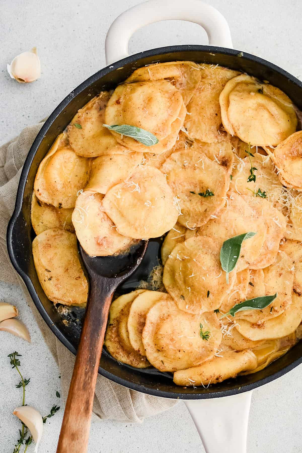 brown butter garlic ravioli in a pan with a spoon