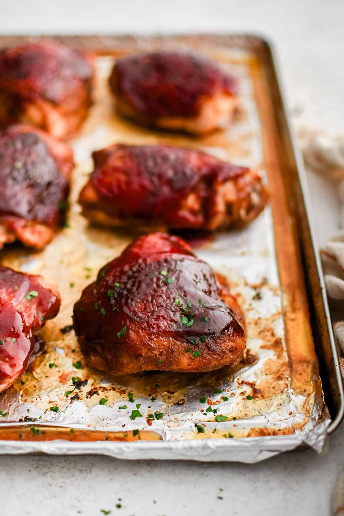 bbq baked chicken thighs on a baking sheet