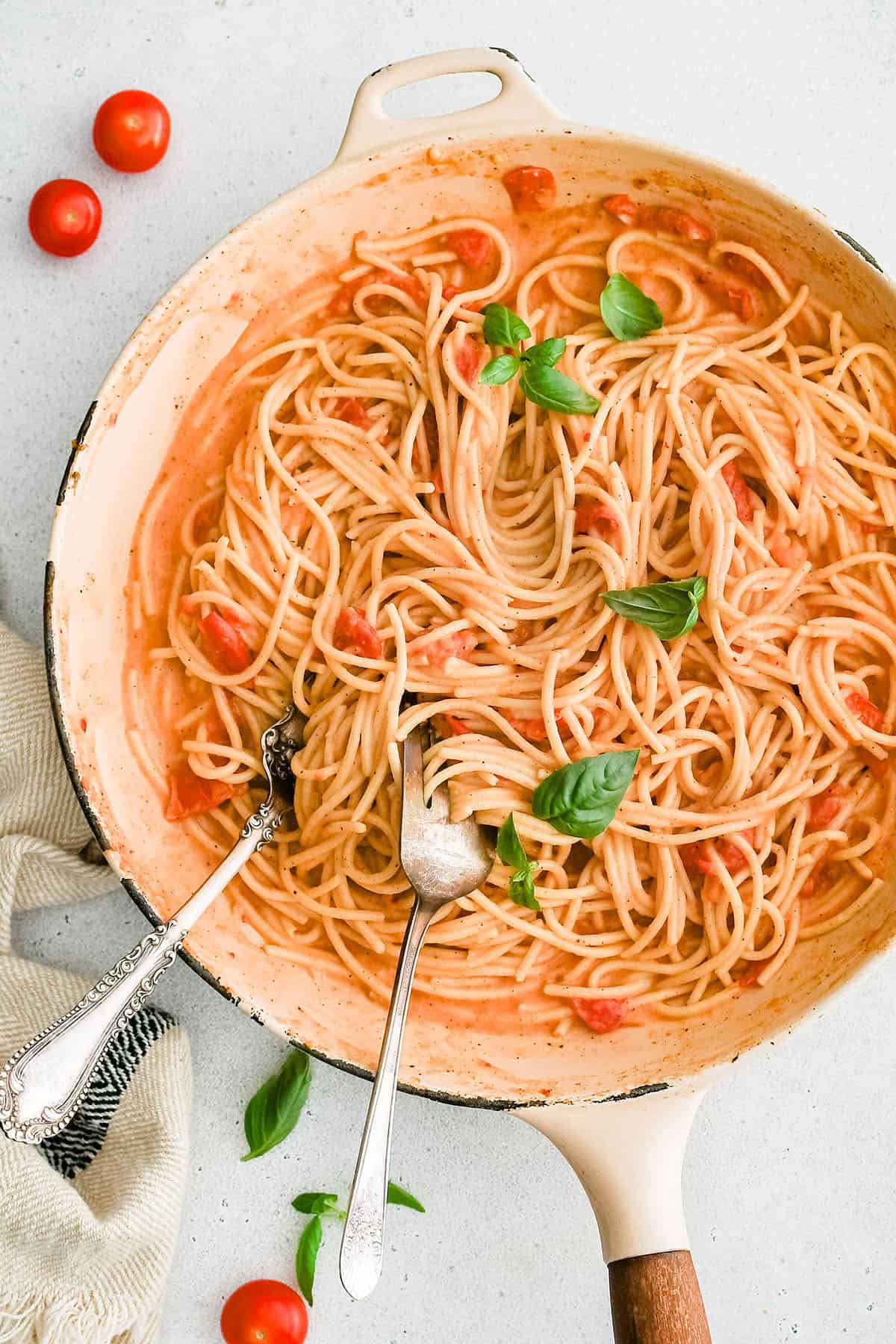 cheesy tomato garlic pasta in a skillet