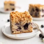 photo of a white plate with a piece of blueberry coffee cake