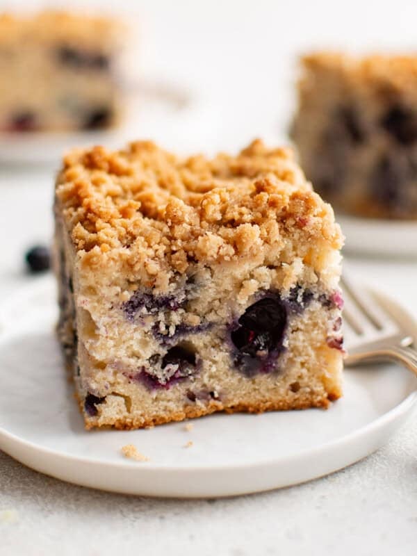 photo of a white plate with a piece of blueberry coffee cake