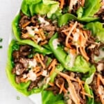 photo of steak lettuce wraps with vegetables and sauce on a plate