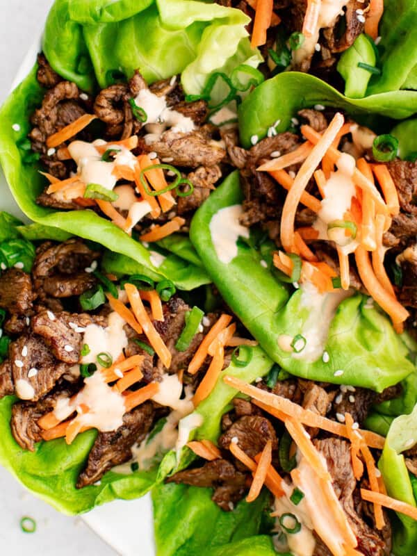 photo of steak lettuce wraps with vegetables and sauce on a plate