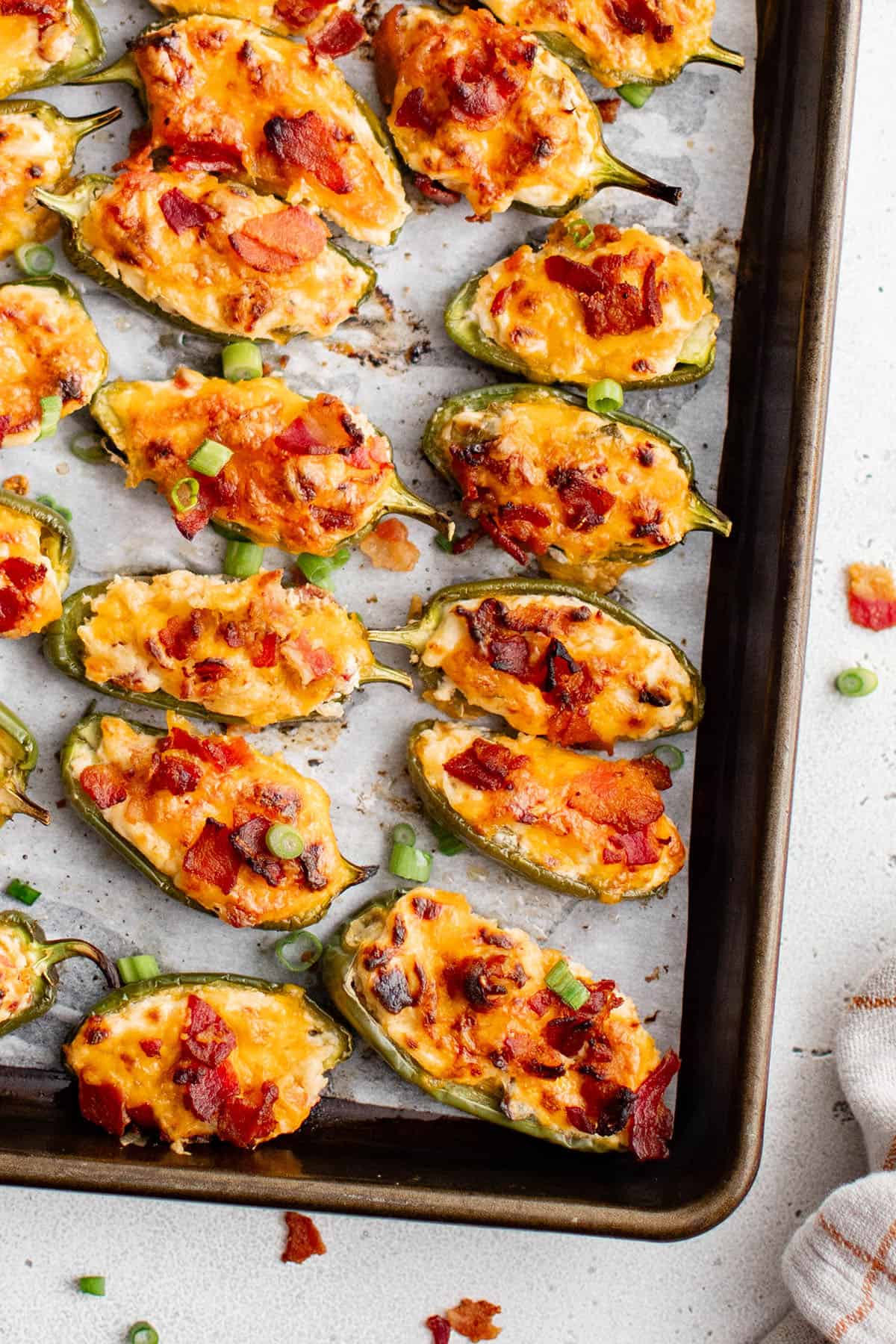jalapeno poppers on a baking pan