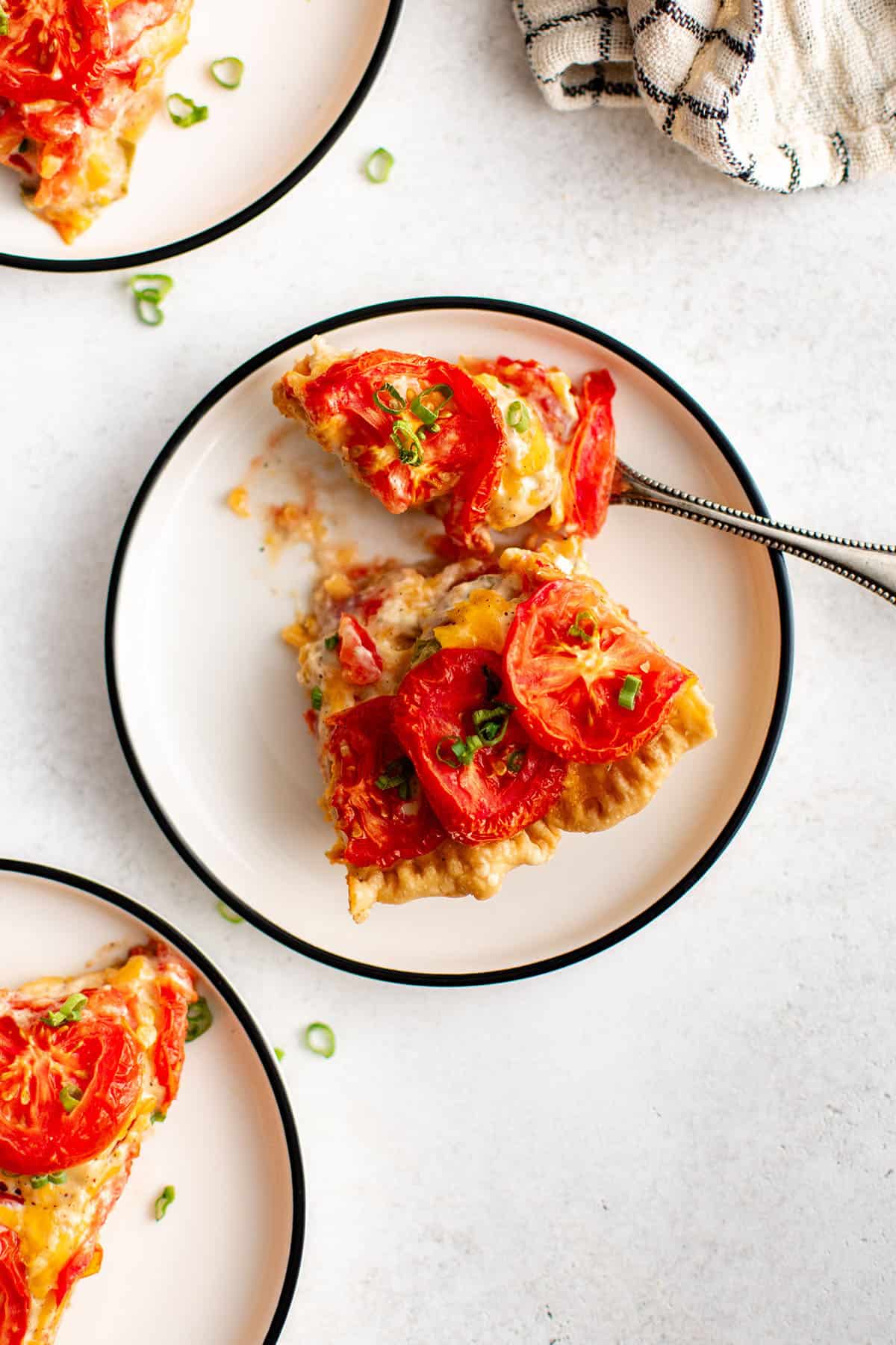 a slice of tomato pie on a piate
