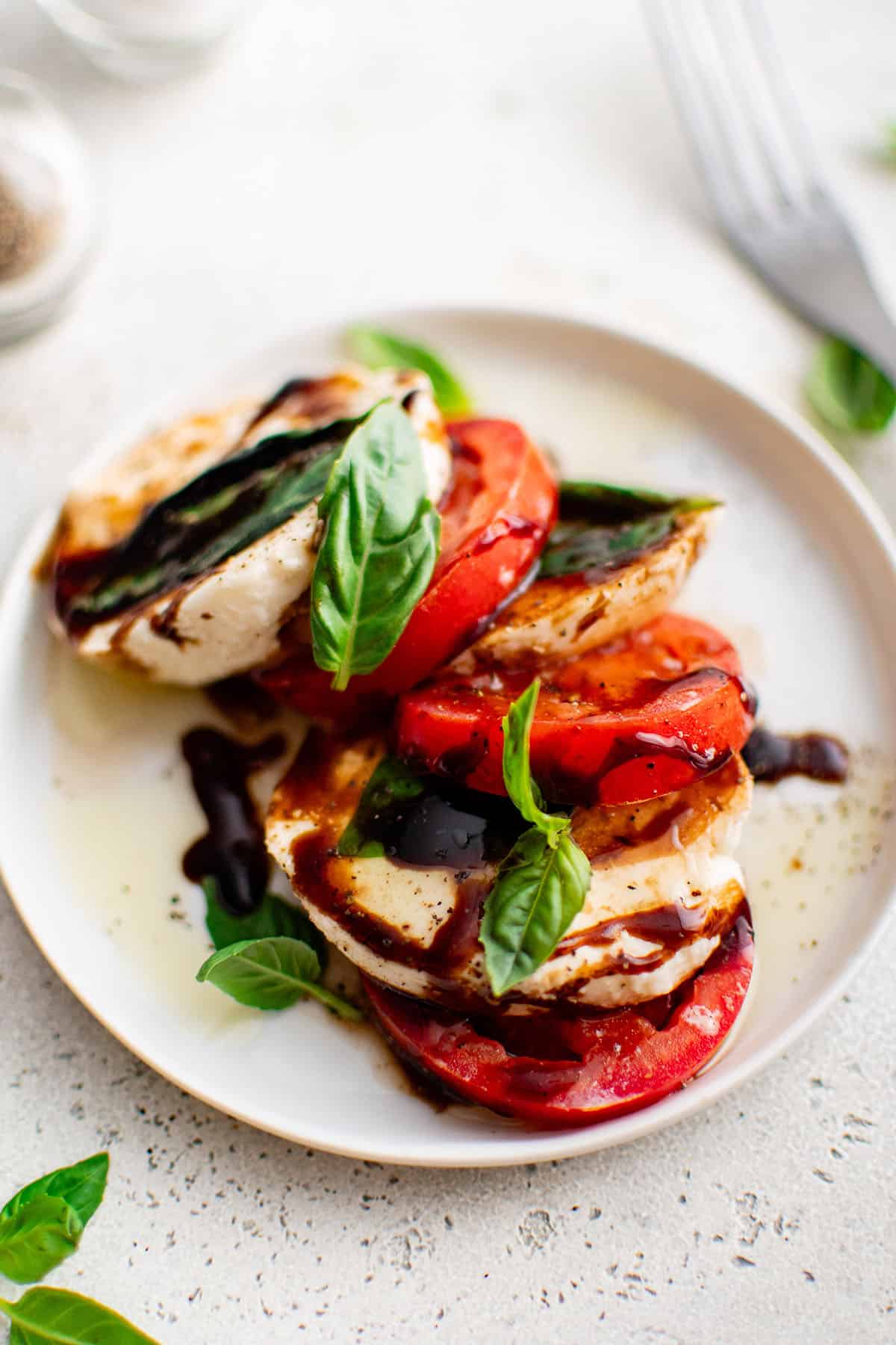 Caprese salad on a round white plate