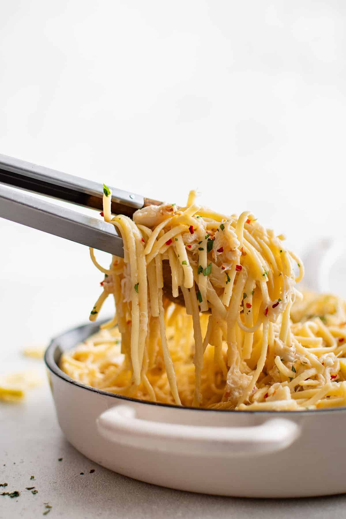 photo of crab pasta in tongs