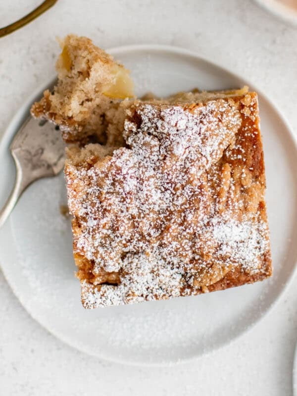 chai spiced pear breakfast cake on a white plate with a fork