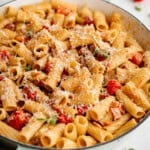 bacon pasta with tomato in a white skillet