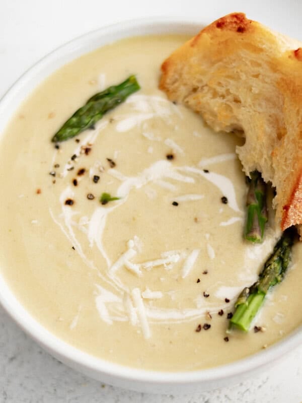 bowl of creamy asparagus soup with bread