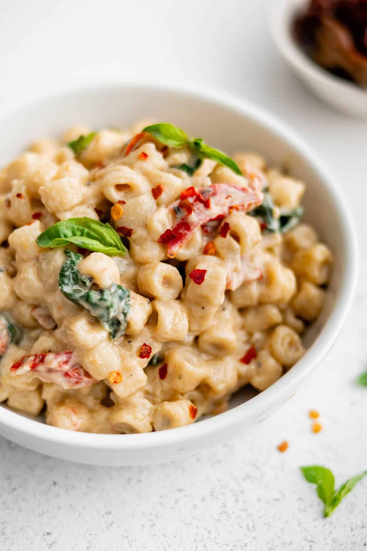 ditalini with sun dried tomato sauce in a white bowl