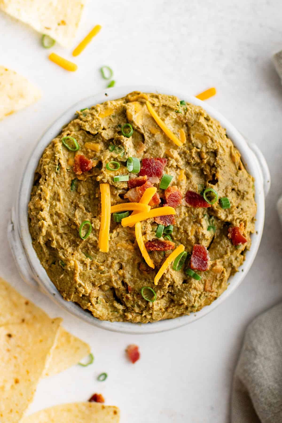 loaded avocado dip in a serving bowl