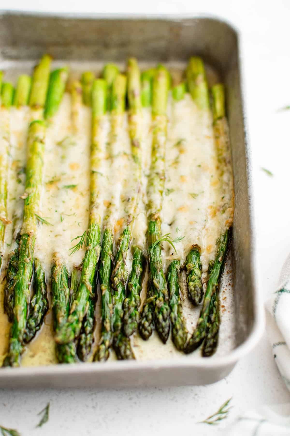 cheesy baked asparagus on a baking dish