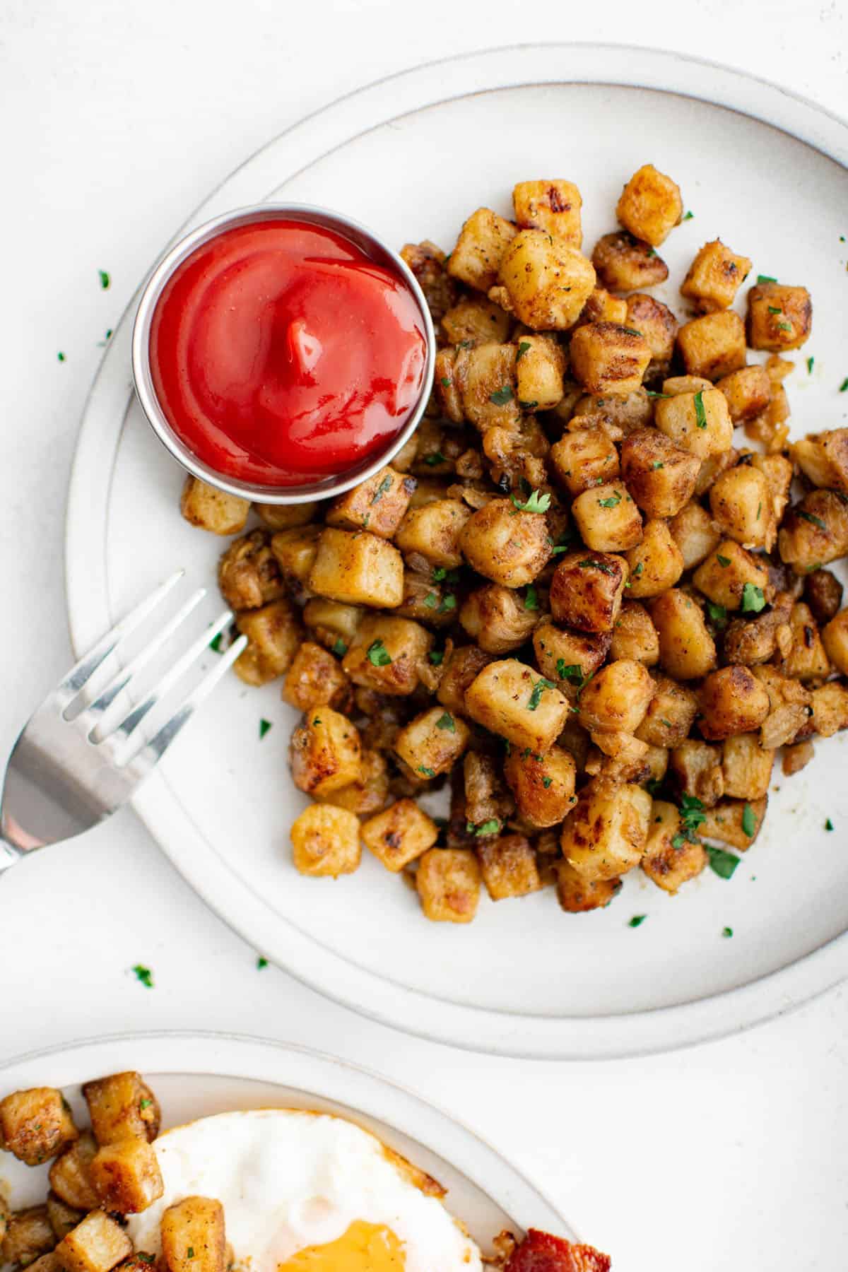 home fries on a plate with ketchup