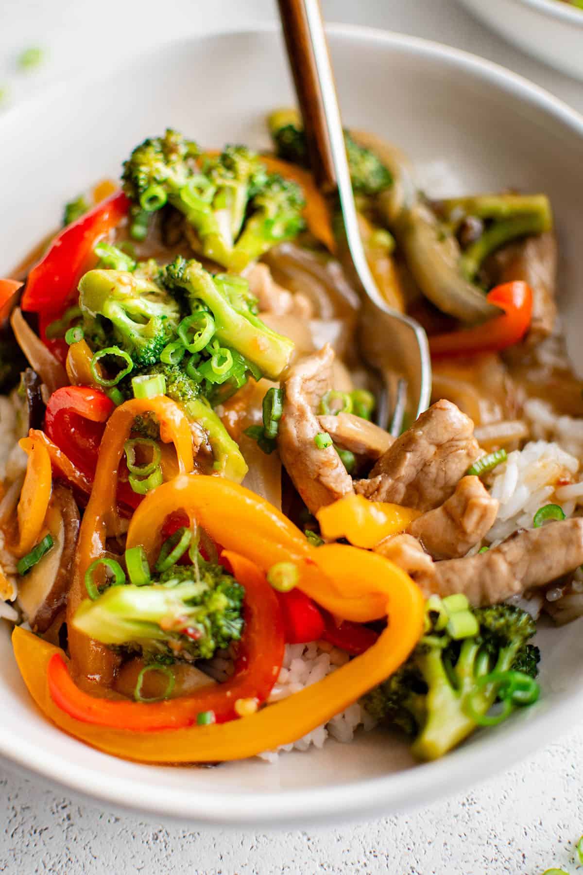 pork stir fry in a white bowl