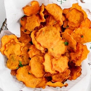 photo of sweet potato chips in a basket with parchment paper