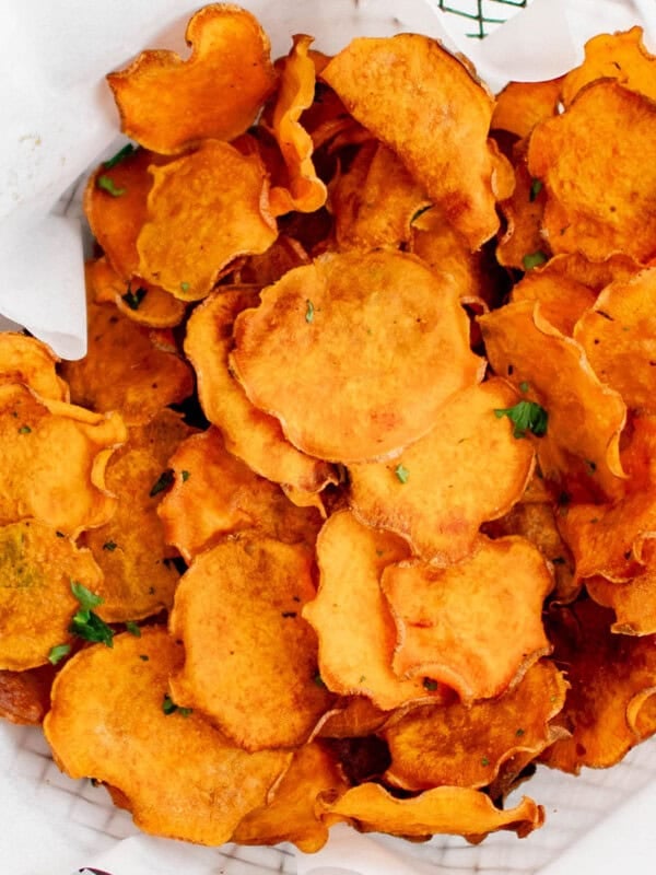 photo of sweet potato chips in a basket with parchment paper