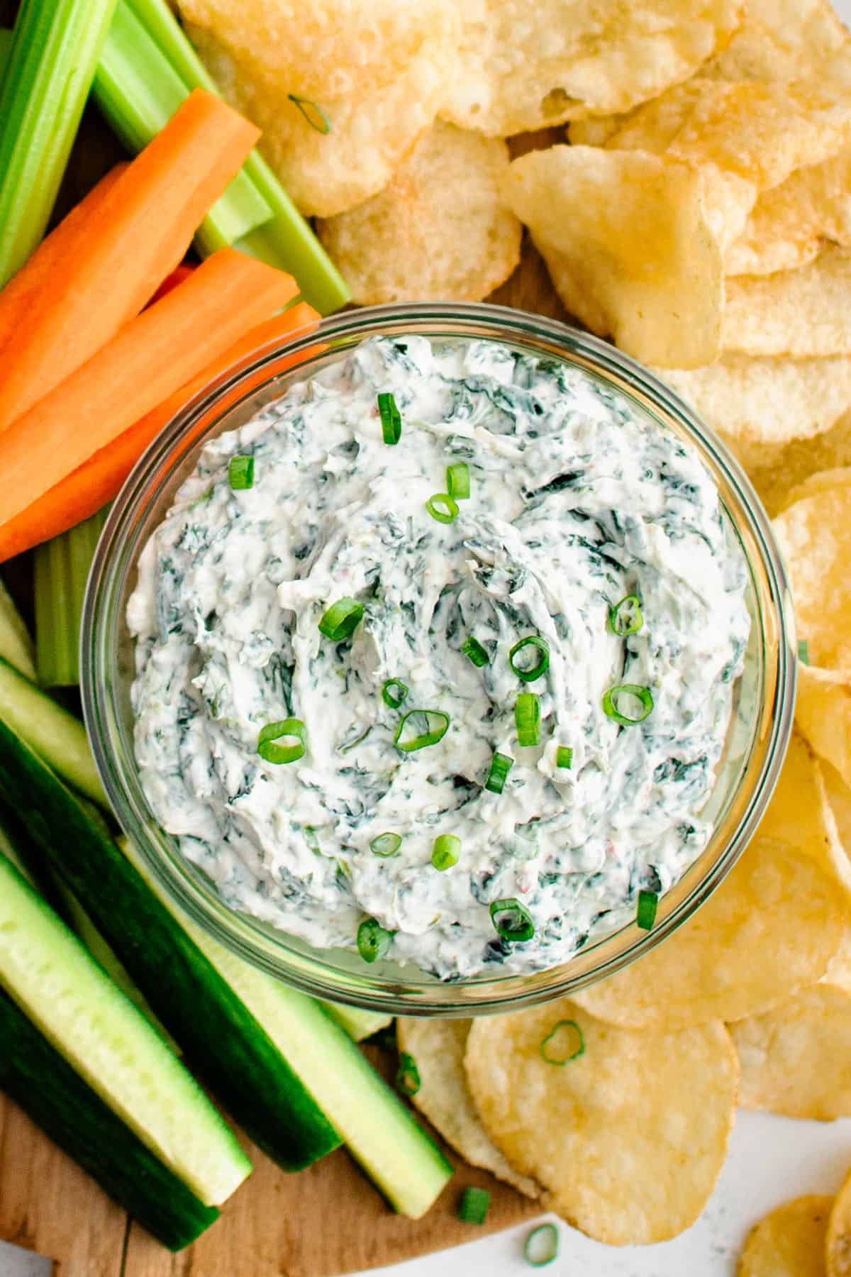 spinach dip with cajun and ranch seasoning served in a bowl with chips and vegetables