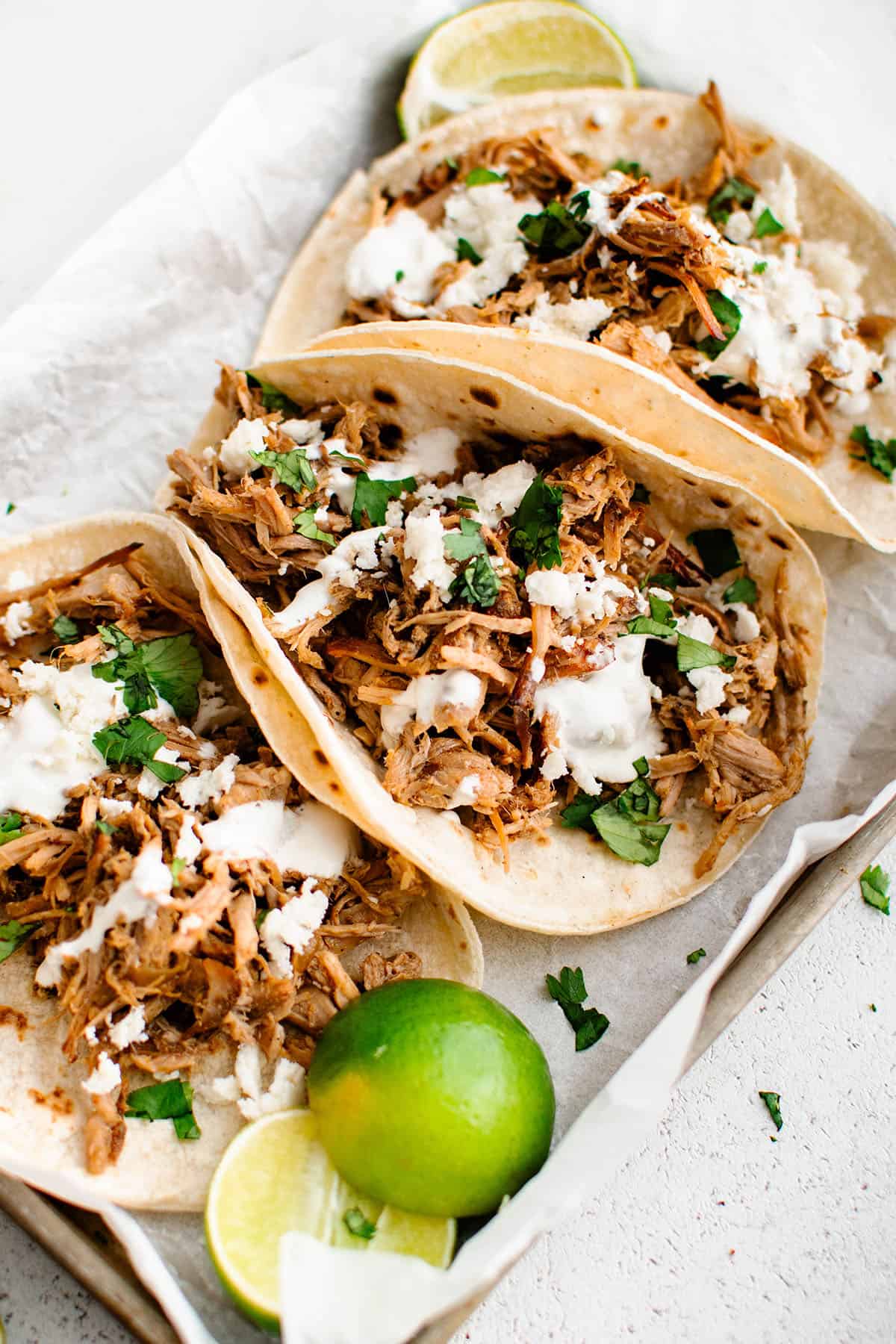 photo of pork carnitas in tortillas with toppings