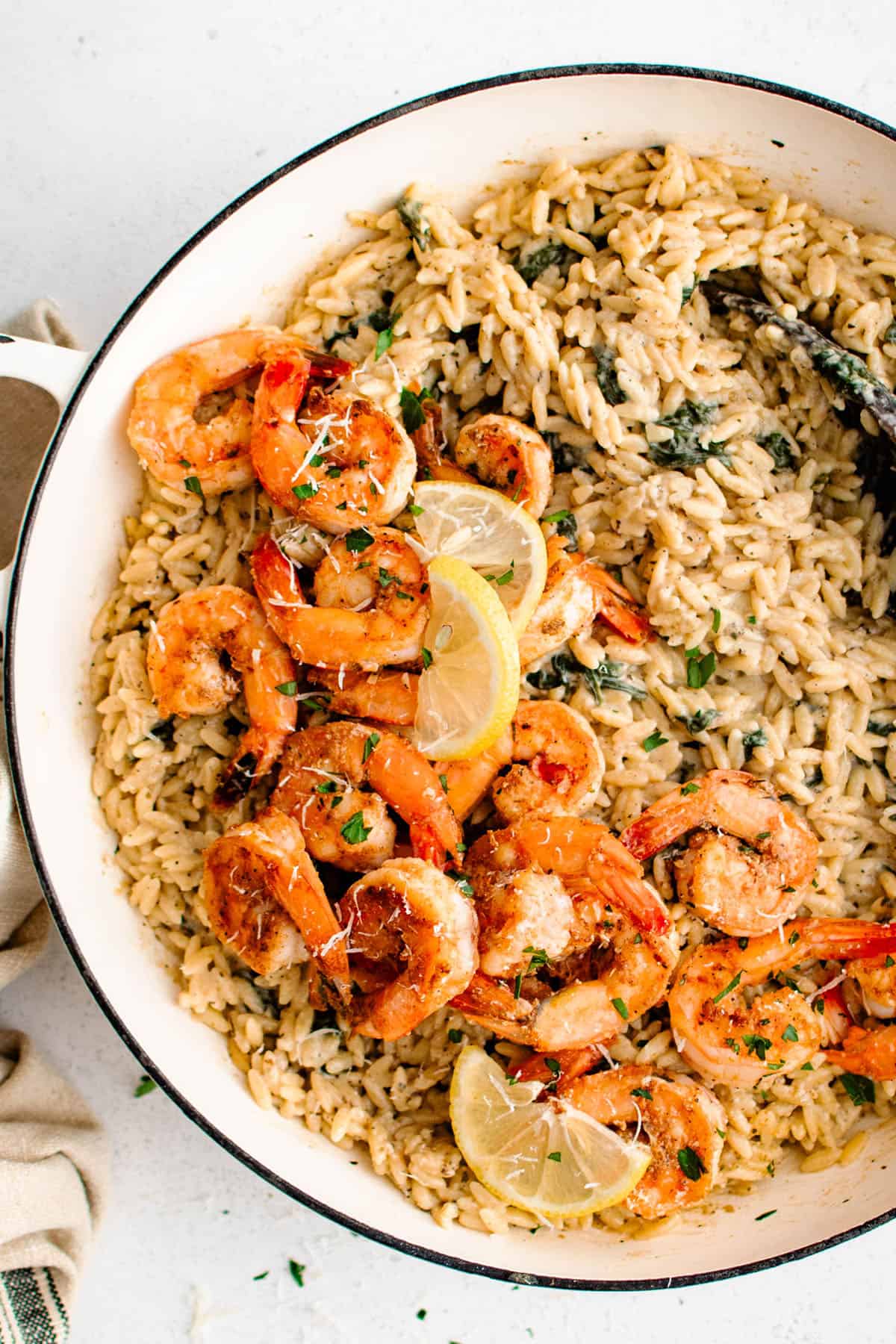 overhead photo of garlic parmesan shrimp orzo in a skillet
