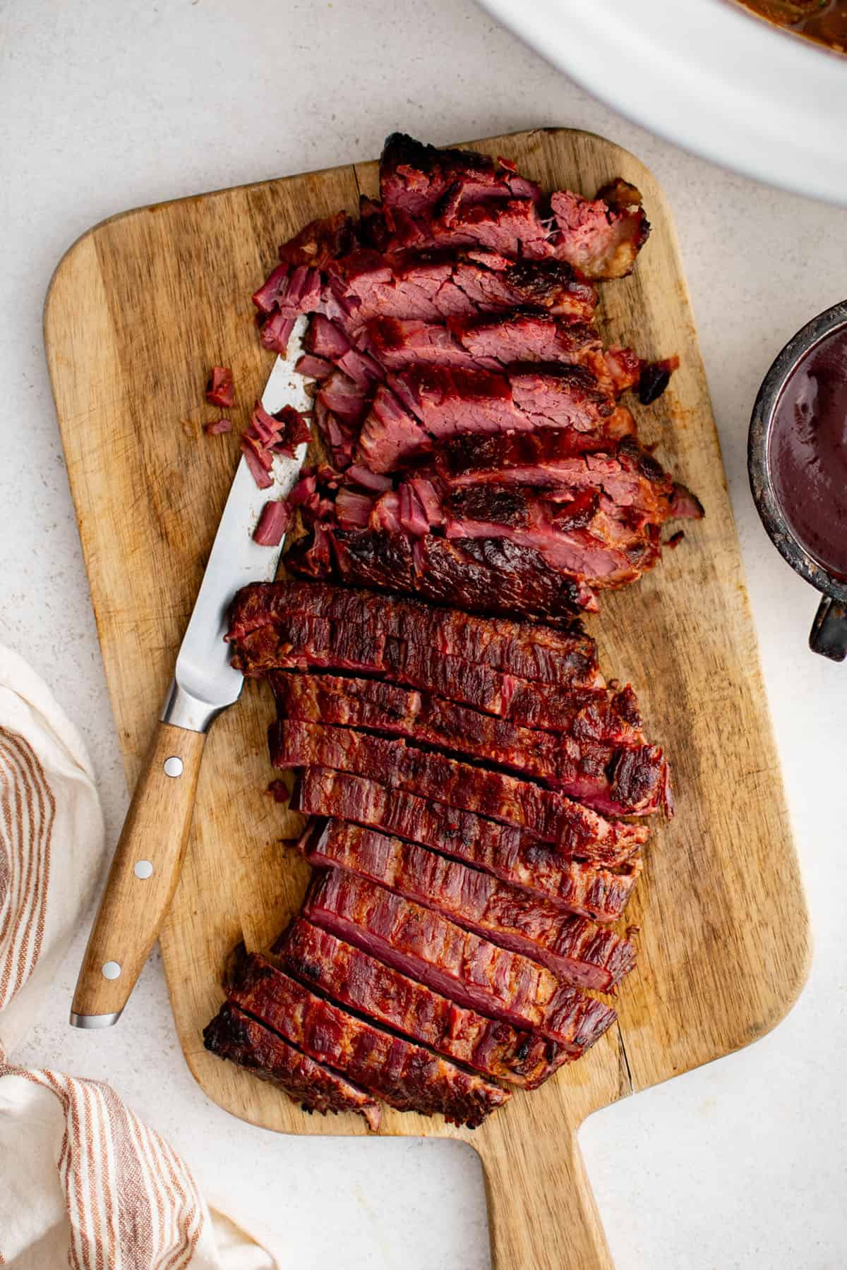 slow cooker brisket on a cutting board sliced into strips