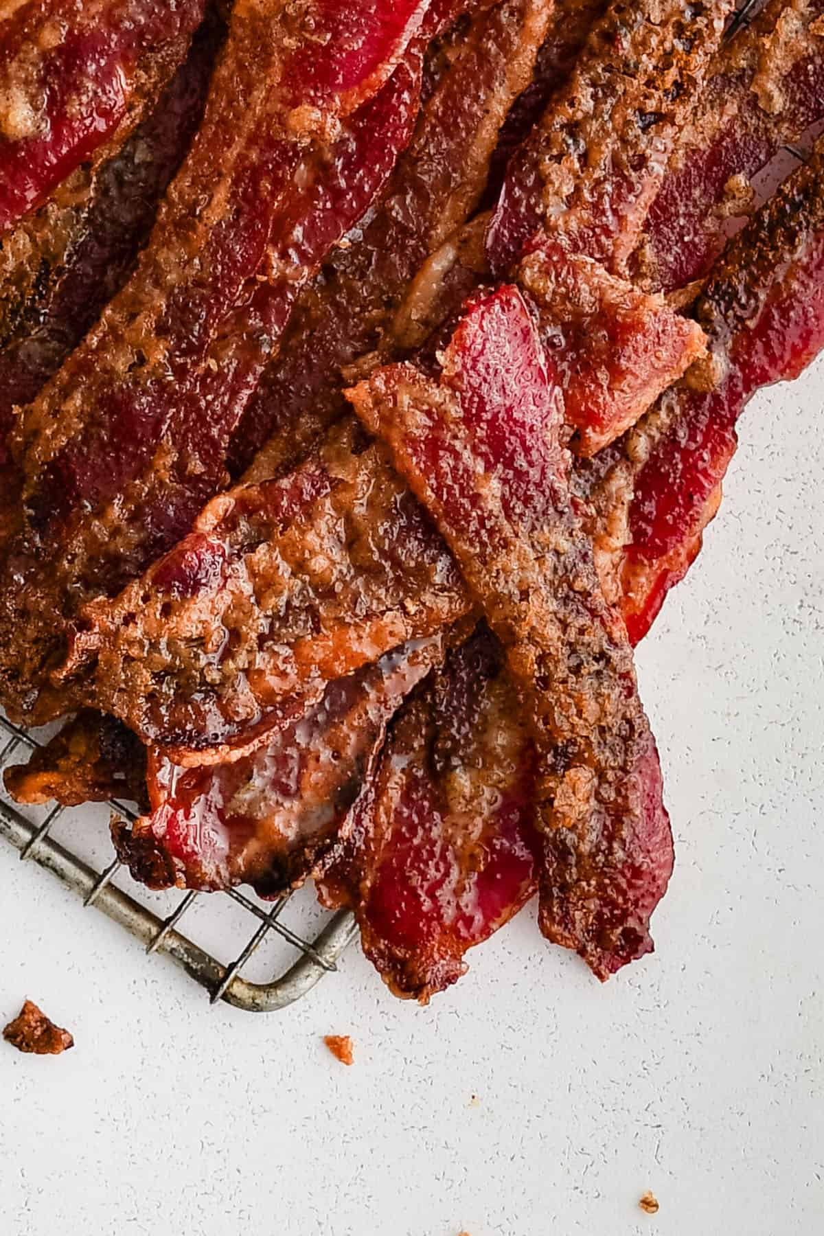 close up picture of candied bacon showing the texture of the glaze on the bacon in great detail
