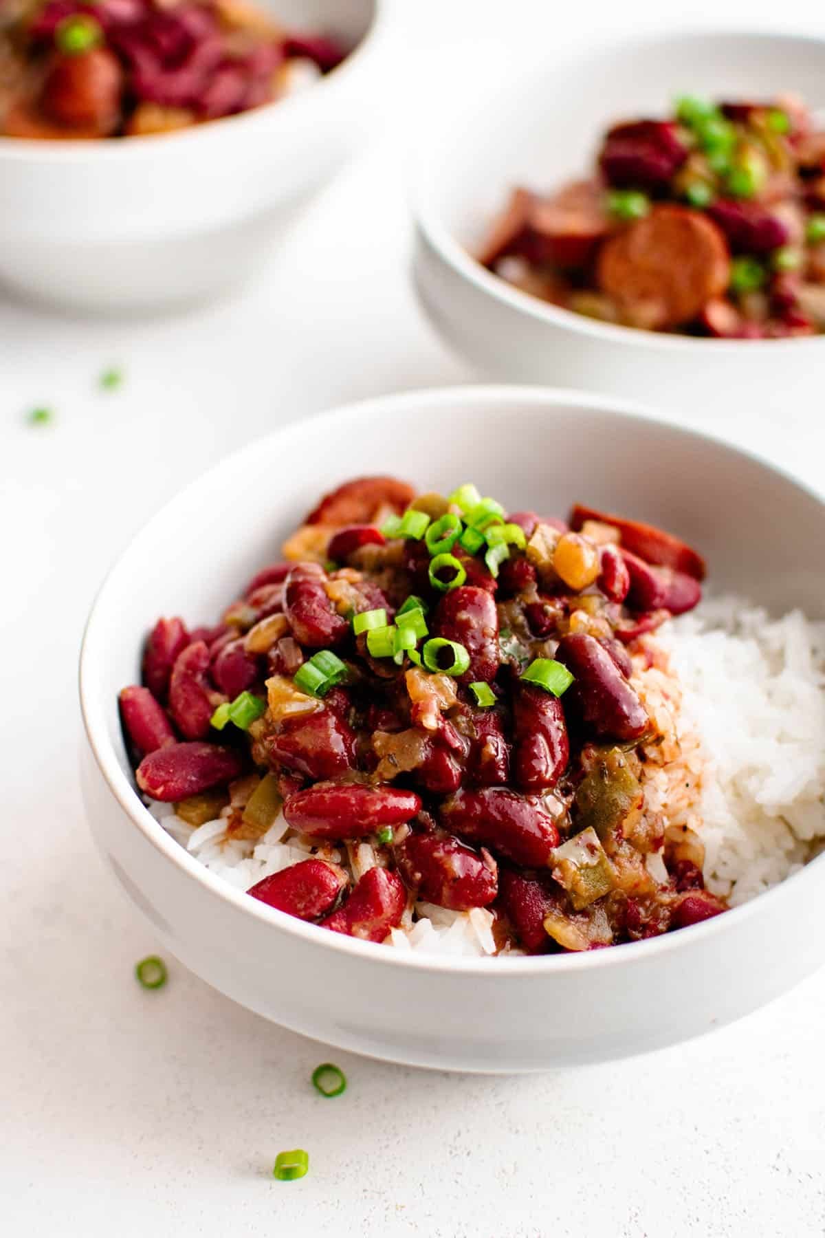 crockpot red beans and rice in a bowl garnished with green onions